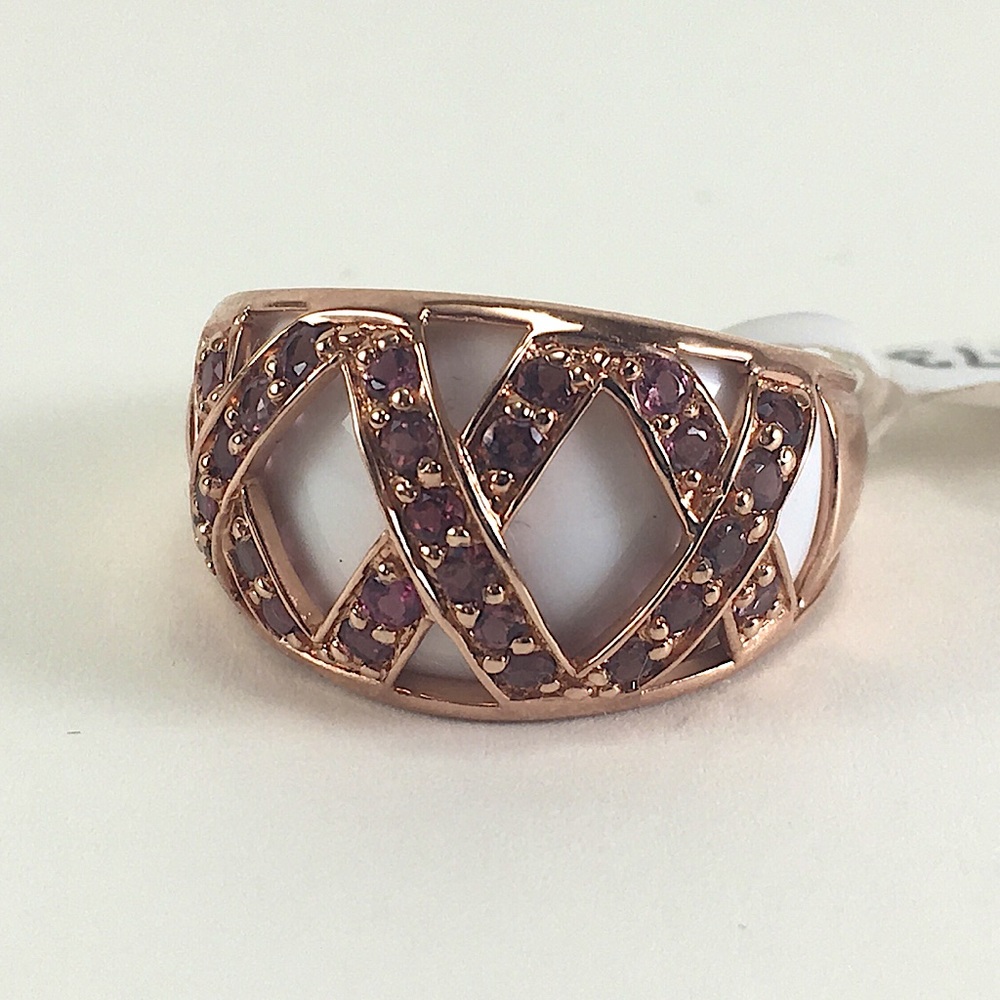 Rose-gold colored ring with pink stones